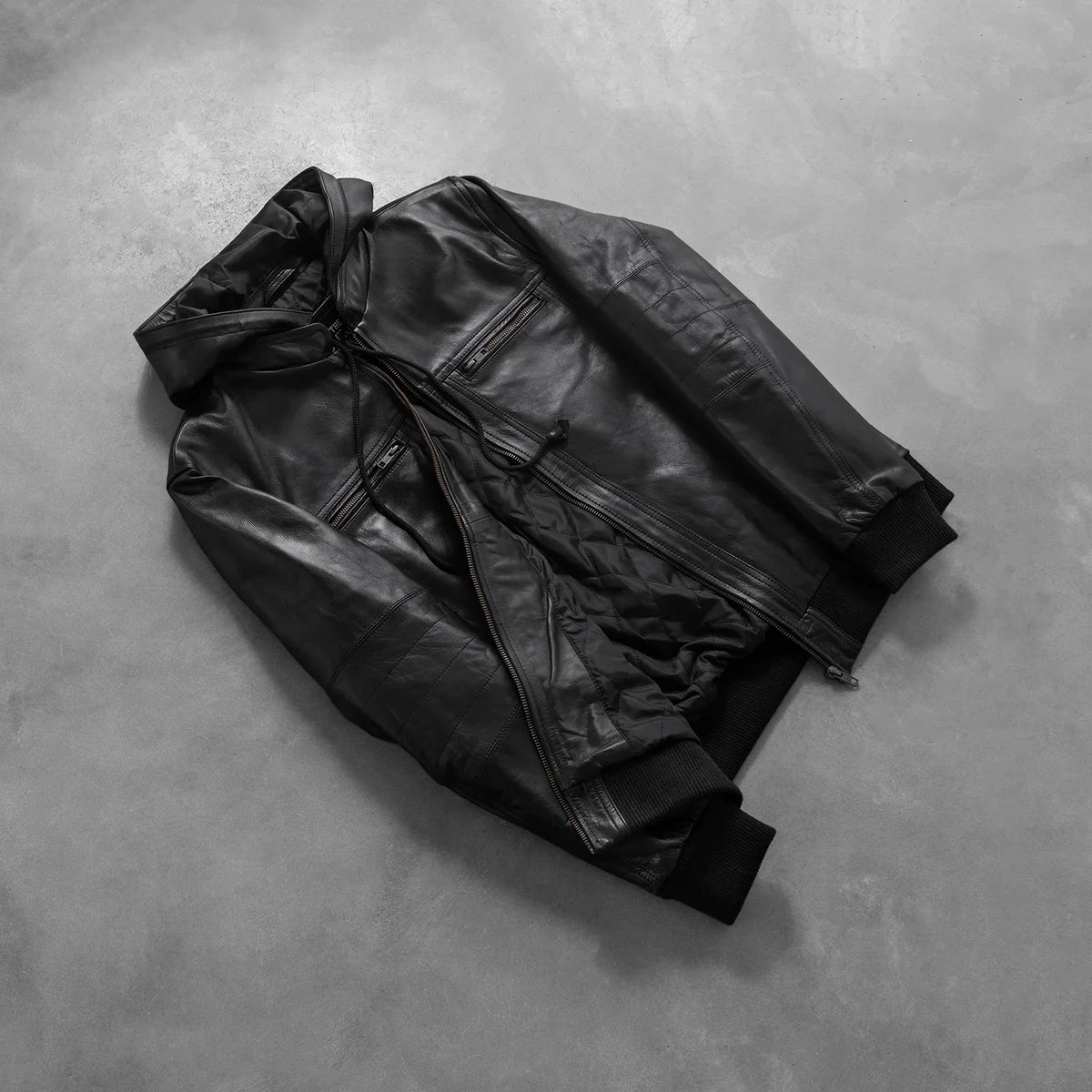 
Styled Fit Perspective of Men's Bouncer Biz Black Leather Hooded Bomber Jacket on Model - Natural Daylight Drape